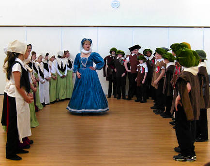 A school take part in a Renaissance period dance.