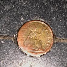 A penny embedded in the north aisle floor